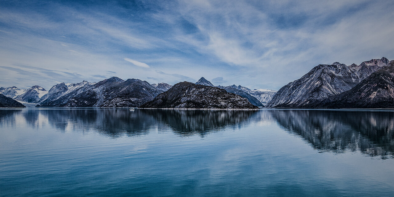 A clear lake in front of a mountain range