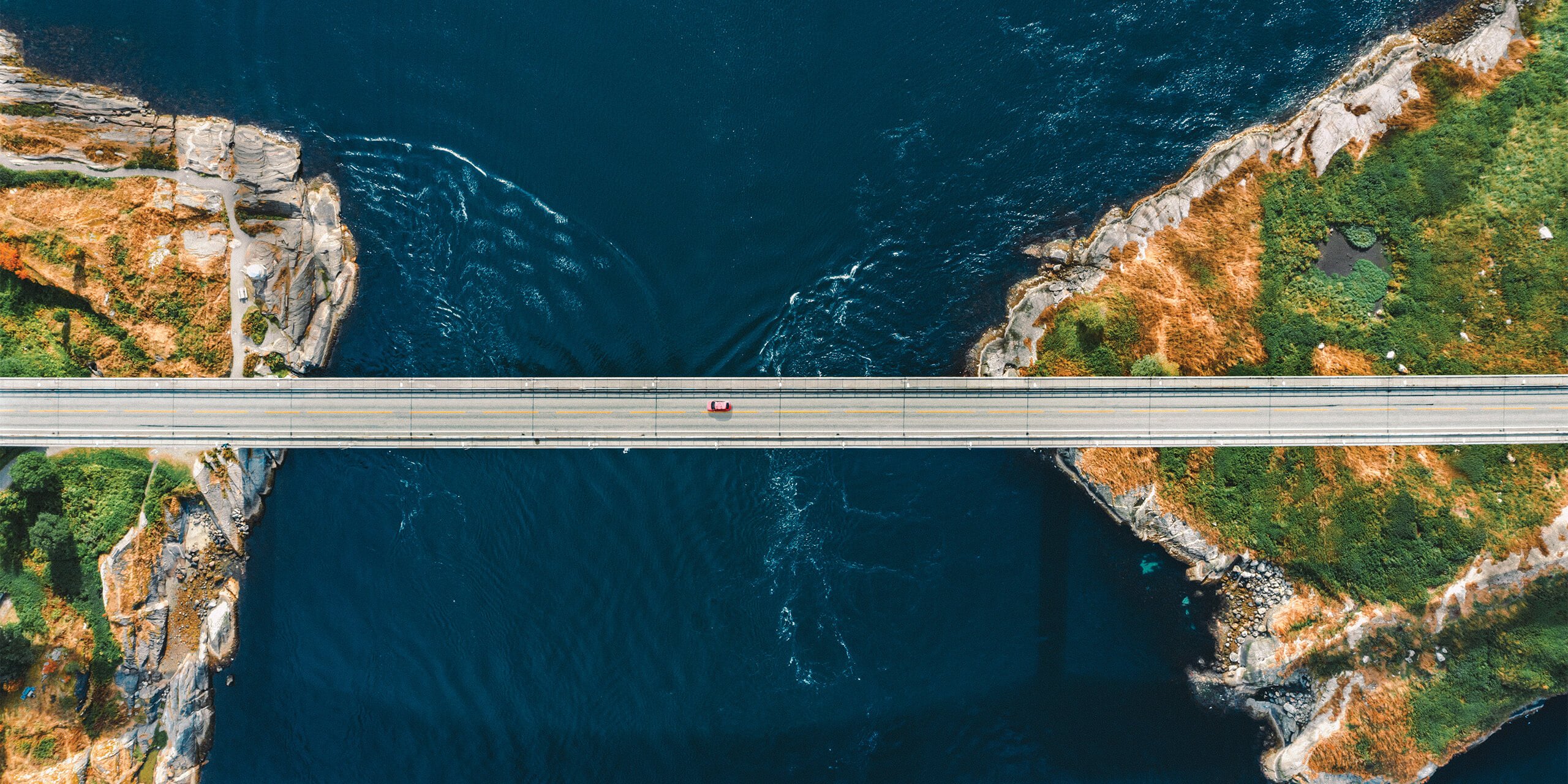 Aerial view of a a bridge connecting islands across the sea